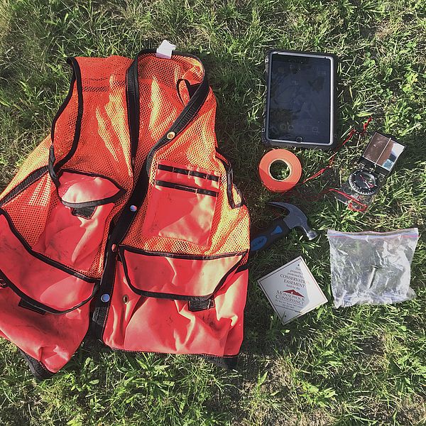 Orange field vest and various items
