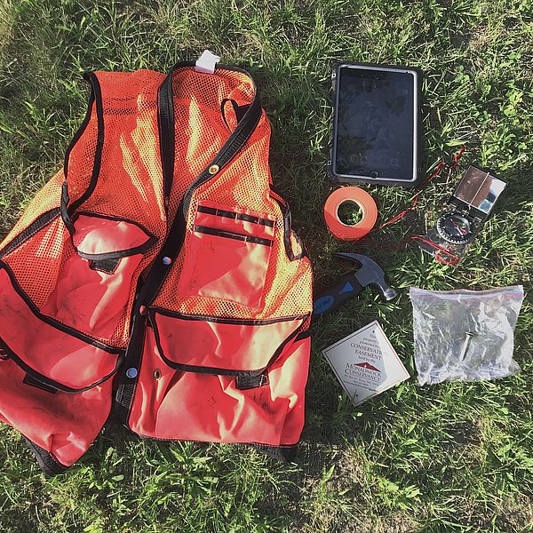 Orange field vest and various items