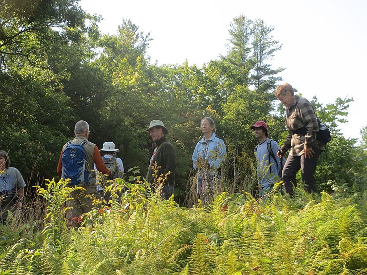 Hikers gather on conserved land. 
