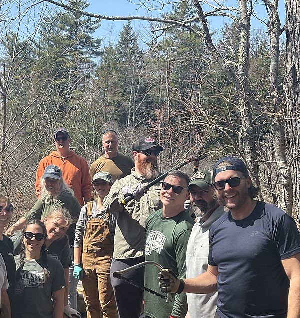 This picture shows a group of people from Bellavance Beverage, along with Conservancy staff, on the boardwalk at the Cranberry Meadow Pond Trial
