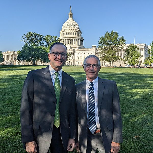 Ryan Owens and Peter Kenyon standing in front of the capitol building in Washington DC